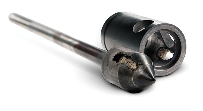 Mechanic inspecting a diesel fuel injector with precision tools